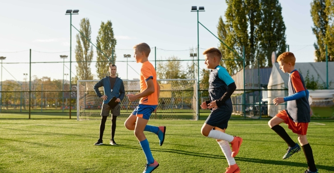 Kids practicing soccer on grass field under footba 2024 11 30 21 54 24 utc min