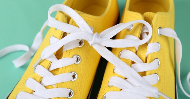 Pair of yellow sneakers on mint background 2023 11 27 05 19 30 utc min