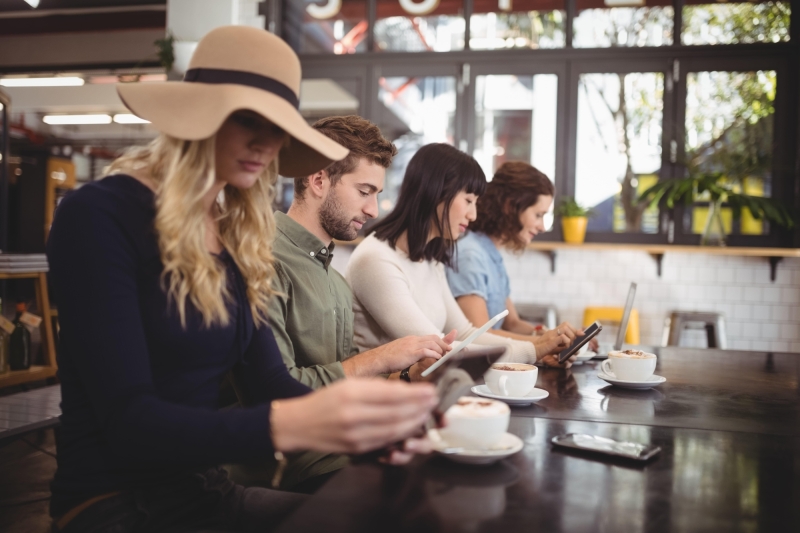 Friends using mobile phones while sitting with cof 2023 11 27 05 24 38 utc min